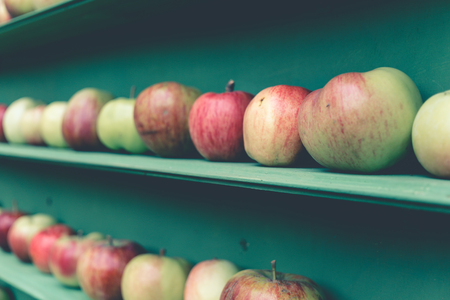 Fresh red and green apple healthy fruit stall in market shelf, selective focusの写真素材