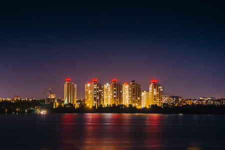 New modern houses in Voronezh, light reflection in water, night photo, tonedの写真素材