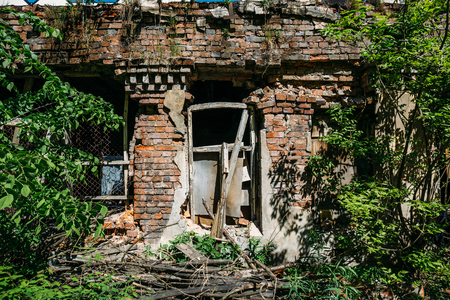 Facade of red brick old ruined abandoned house in St. Petersburgの写真素材