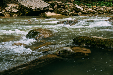 Tranquil mountain river stream landscape, flowing water, tonedの写真素材