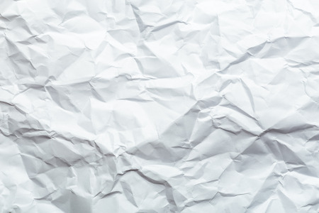 Crumpled white paper background texture for usage in designの写真素材