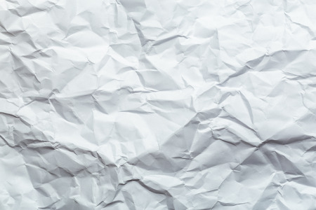 Crumpled white paper background texture for usage in designの写真素材