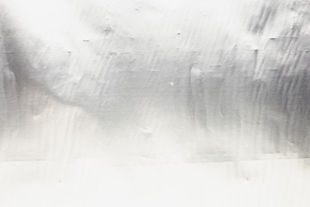 Metal silver steel foil texture close up as abstract shiny chrome backgroundの写真素材