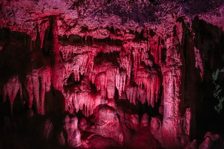 Stalactites in an underground cave with a violet backlight, tonedの写真素材