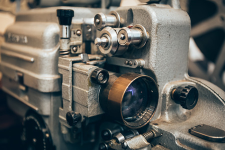 Close-up of a vintage metal film projector with lens, retro tonedの写真素材