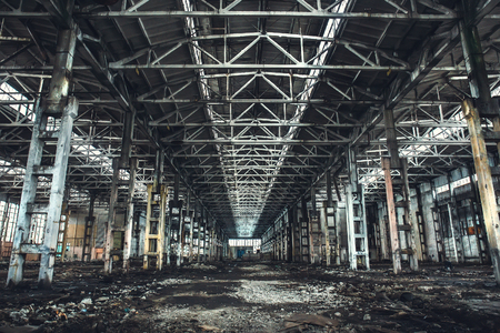 Large empty abandoned warehouse building or factory workshop, tonedの写真素材