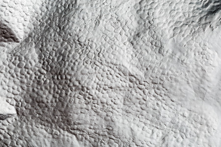 Silver crumpled foil shiny metal texture background for use in design as wallpaper decorationの写真素材