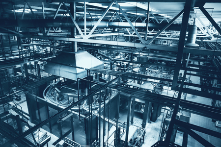 Industrial factory, steel pipelines, tubes at brewery production. Large workshop with tools equipment, blue tonedの写真素材