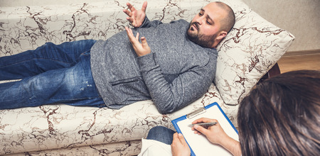 Psychologist consulting and psychological therapy session concept. Fat man with depression and...