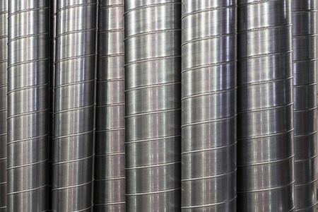 Steel or metal round pipes as industrial background, vertical pipeline air ventilation tubesの写真素材