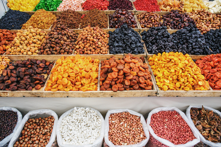 Dried fruits on food market, boxes with colorful various assortment of vegetarian healthy dry fruitsの写真素材