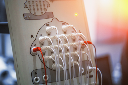 Modern encephalograph in clinic. EEG or Electroencephalography research concept, toned with light effectの写真素材