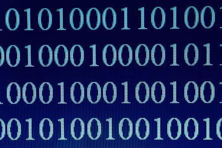 Binary Code on computer screen, macro shot. Technology internet background, blue toned