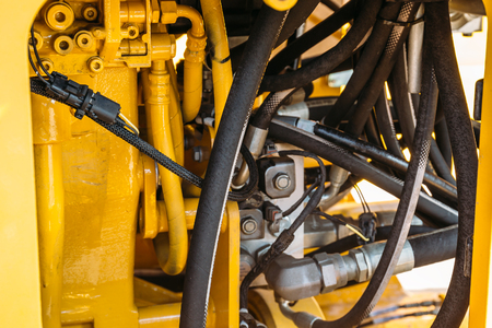 Hydraulic system, steel tubes and rubber parts of lifting mechanism of modern tractor or excavator, agricultural machinery, close upの写真素材