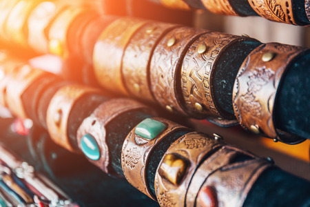 Braided handmade leather bracelets, selective focus, sunlight effect, tonedの写真素材