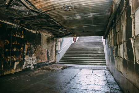 Burned underground pedestrian crossing after a fire or terrorist attack, walls in soot and smoke, dark tonedの写真素材