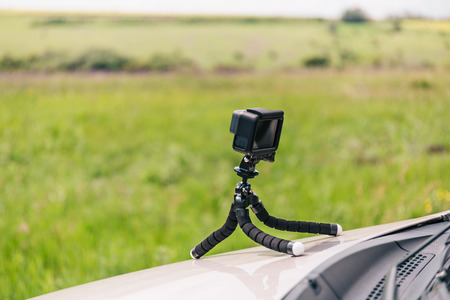 Action camera on flexible tripod on the hood of car recording  time-lapse, copy spaceの写真素材