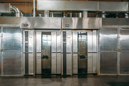 Industrial cabinets-ovens or stoves for preparation of biscuits and bakery at confectionery factory, machine modern equipment.の写真素材