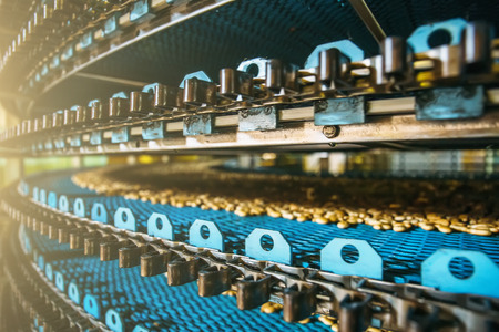 Close up of conveyor line at Confectionary factory, food industry. Cookie and pastry production.の写真素材