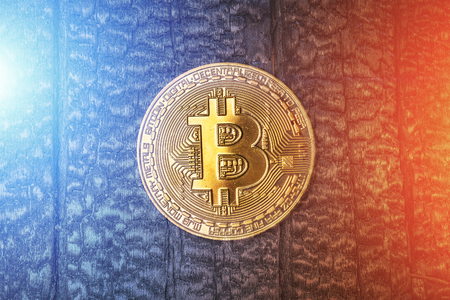 Cryptocurrency golden bitcoin coin on grunge background with light effects. Symbol of crypto currency - electronic virtual money for web banking and international network payment, tonedの写真素材