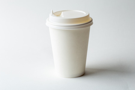 White paper disposable cup on white background, mockup coffee cup with lid, minimalism creative design, close upの写真素材