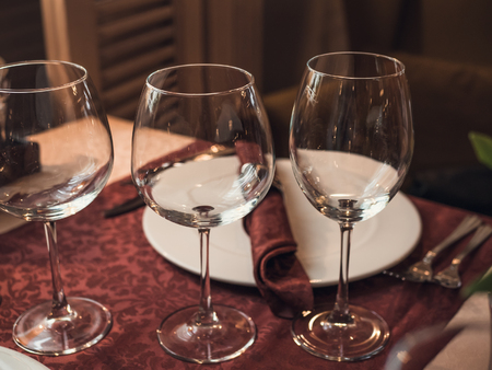 Empty glasses in restaurant or cafe, toned, selective focusの写真素材