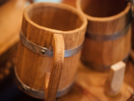 Old wooden handmade mugs for beer or ale, close up with selective focus