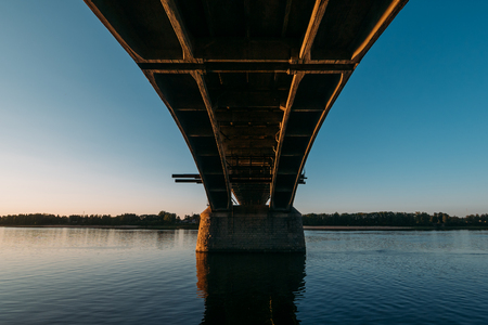 Volga bridge and embankment over Volga river at sunset, Yaroslavl region, Rybinsk city, Russia. Beautiful landscape with waterの写真素材