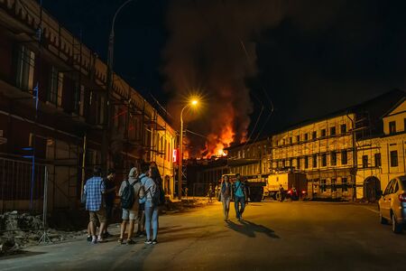 Rybinsk, Russia -31 July 2018 : Large night fire, burning modern building, smoke clouds, flames, people on the street watching the fireのeditorial素材