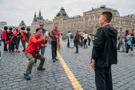 Moscow, Russia - Circa September 2018 : Group of happy Asian tourists takes photo on red Square in Moscow. International travel tourismのeditorial素材