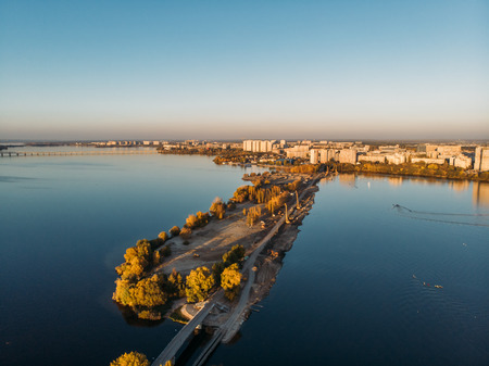 Aerial panoramic view of cityscape with river in sunny day, autumn city landscape from above, tonedの写真素材