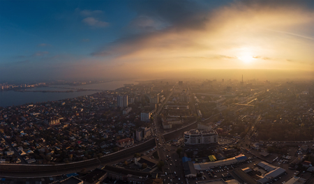 Aerial panorama of dramatic sunset above evening Voronezh city in haze or fog, bird eye view of urban downtown architecture in twilight, tonedの写真素材