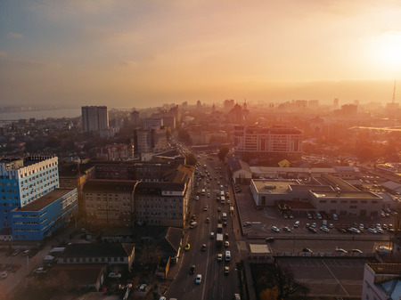 Aerial panorama of dramatic sunset above evening Voronezh city in haze or fog, bird eye view of urban downtown architecture in twilight, tonedの写真素材
