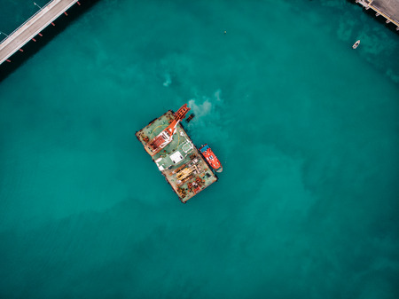 Offshore industrial platform or tower with crane or science sea research center, top or aerial view...