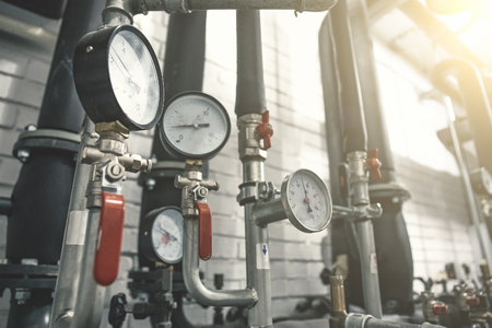 House heating system with many steel pipes, manometers and metal tubes, selective focus, tonedの写真素材