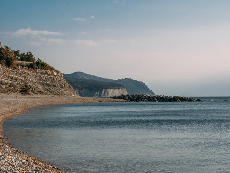 Sea coast with stone beach in gloomy cloudy day with copy space.の写真素材