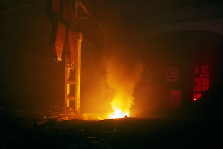 Fire in factory building at night. Burned by fire industrial warehouse, tonedの写真素材