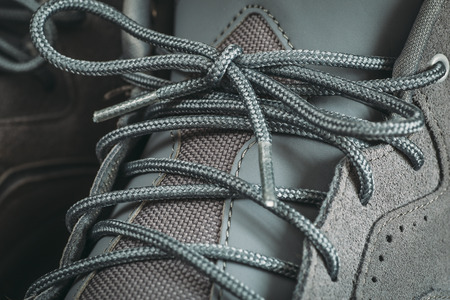 Knotted shoelace sneakers for sports, fitness. Laces on training and lifestyle footwear, close up.の写真素材