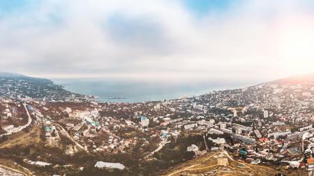 Aerial panorama of winter Yalta, old European city on Black Sea, town on mountains, beautiful resort landscape, tonedの写真素材