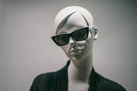 Female mannequin in sunglasses in boutique. Dummy head close up in fashion store.の写真素材