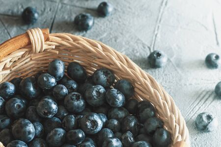 Fresh Blueberries in Wooden Basket on Table. Raw Organic Bilberry Close Up for Healthy Eating, Top Viewの写真素材