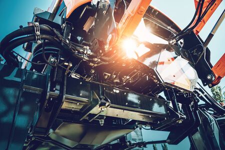 Part of agriculture machine close up with hydraulic system, steel tubes, industrial tools equipment, tractor or harvester, tonedの写真素材