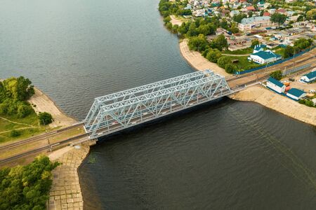 Aerial or top view of steel railroad bridge over river, train transportation concept.の写真素材