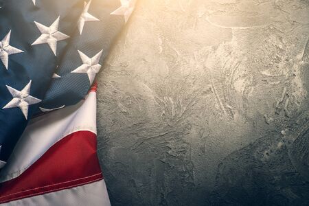 American or USA flag on concrete background with copy space for text, top view, toned
