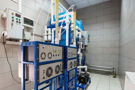 Automated ozone generator for ozonation of pure drinking water in water production factory, close up
