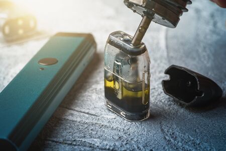 Refill with e-juice or liquid with salt nicotine of replacement cartridge for vape pod or new vape pen device.の写真素材