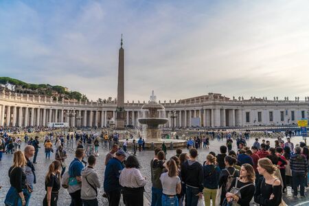 Vatican City, Rome, Italy - Circa October 2019: Piazza San Pietro square with fountain and Basilica di San Pietro at Vatican City with tourists on street.のeditorial素材
