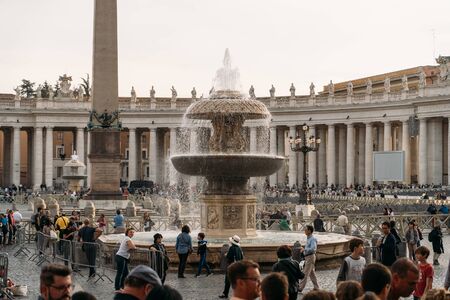 Vatican City, Rome, Italy - Circa October 2019: Piazza San Pietro square with fountain and Basilica di San Pietro at Vatican City with tourists on street.のeditorial素材