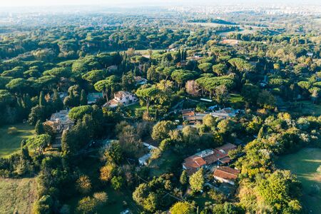 Aerial view of ancient Via Appia Antica with green trees, meadows, houses and pathways in Rome, Italy.の写真素材