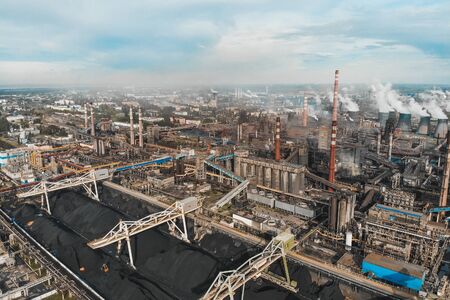 Aerial panoramic view of Factory or Plant Industrial Area with many pipes or chimneys with smoke,...